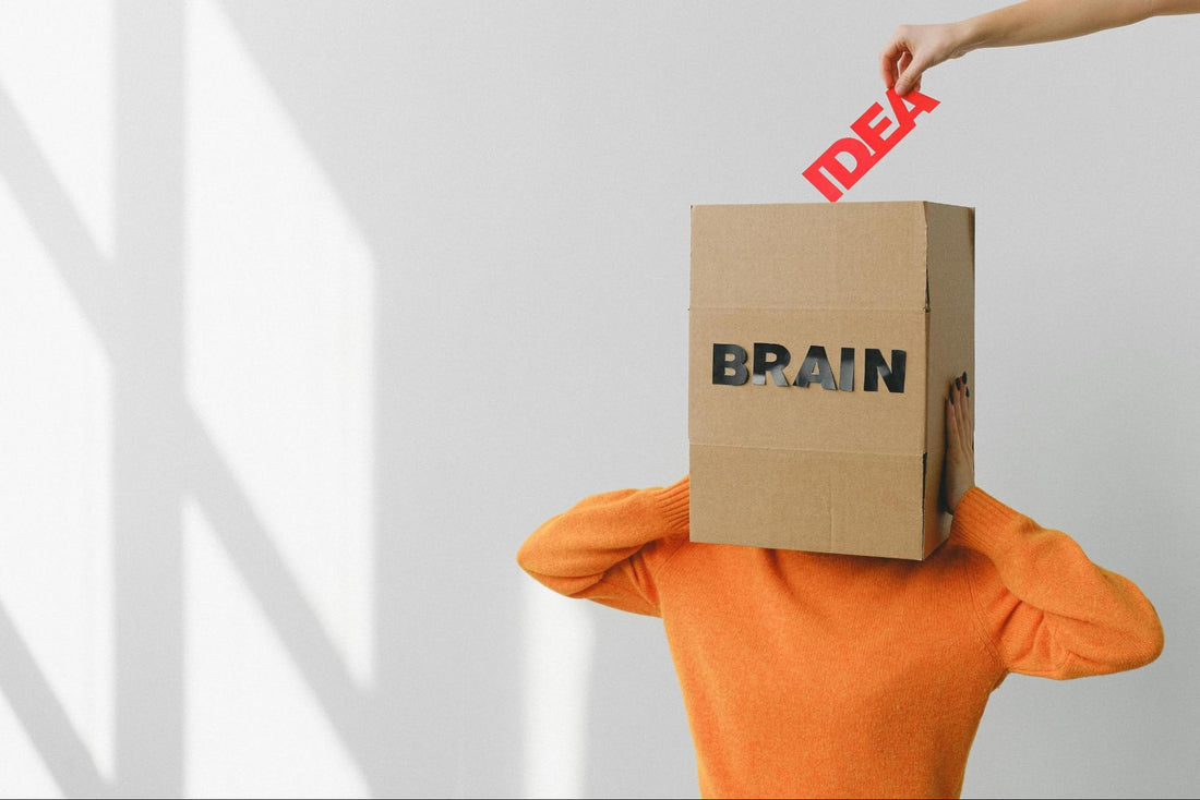 Person with Box on their Head with “Brain” and “Idea” Being Put in