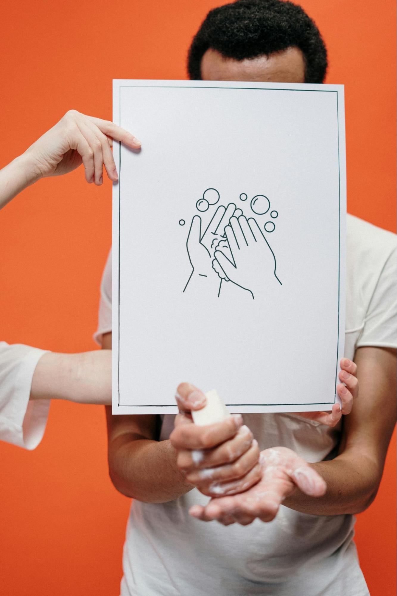 Man with Handwashing Sign