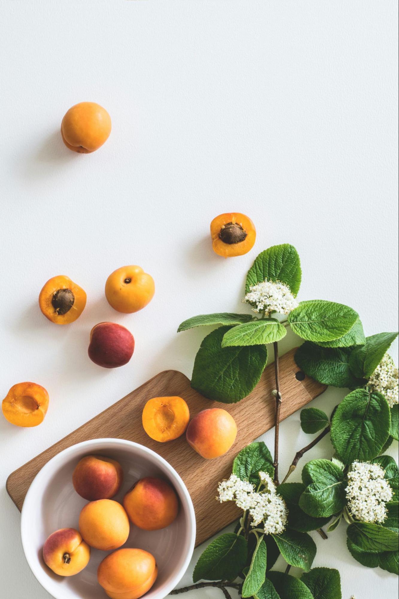 Fruit in a Bowl with Cutting Board and Flowers