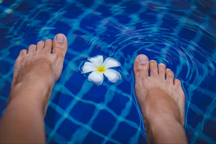 Person Dipping Feet into Pool 