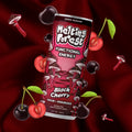A can from the Mushroom Energy Drink 12 Pack - Variety Pack with lion's mane, surrounded by cherries, cherry halves, and illustrated red mushrooms on a dark red fabric background.